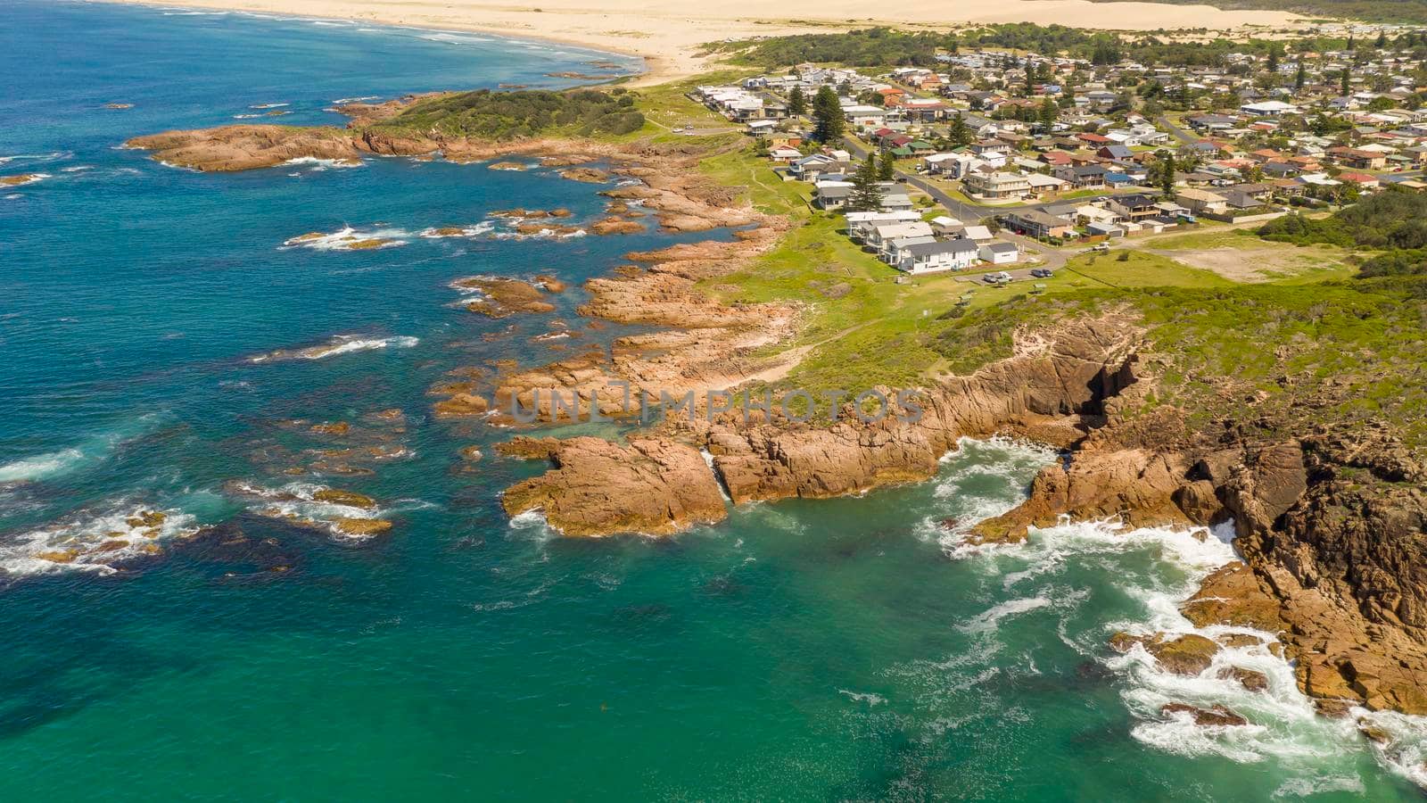 Aerial view of the Stockton Sand Dunes and blue water of the Tasman Sea at Birubi Point near Port Stephens in regional New South Wales in Australia