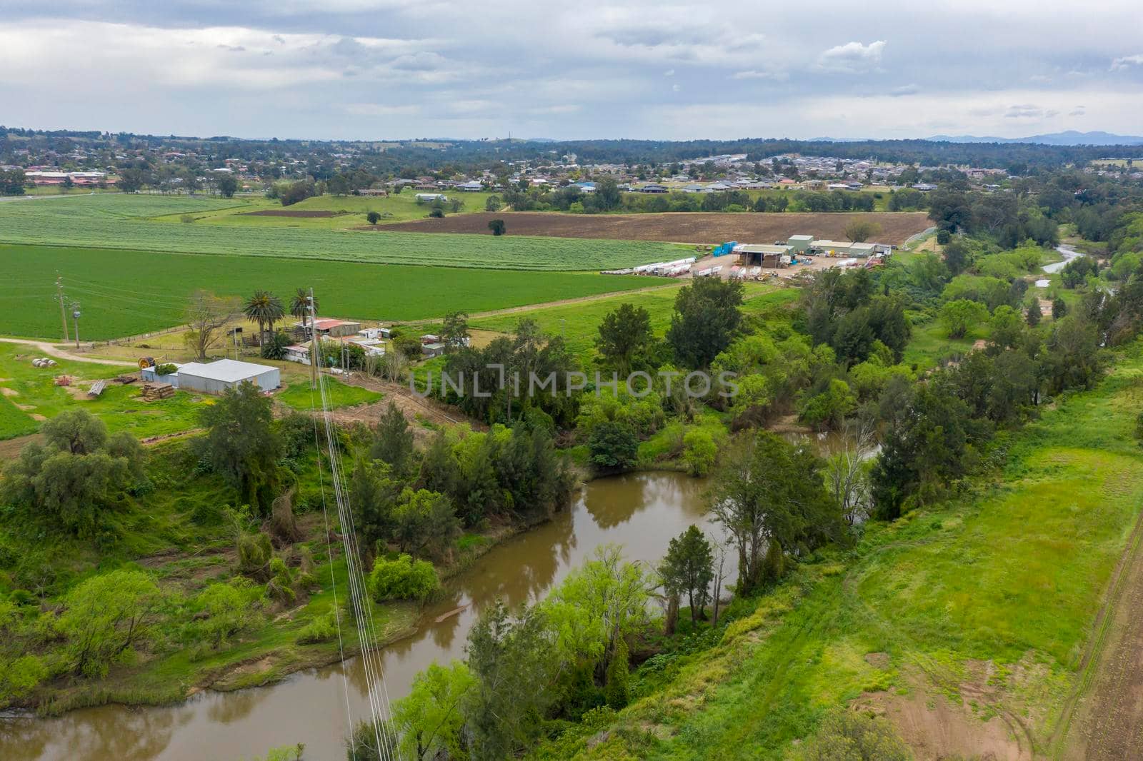 Aerial view of green farmland in regional New South Wales in Australia by WittkePhotos