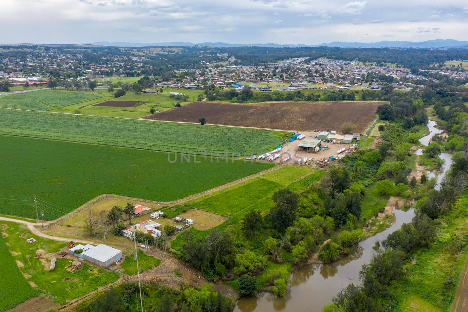 Aerial view of green farmland in regional New South Wales in Australia by WittkePhotos