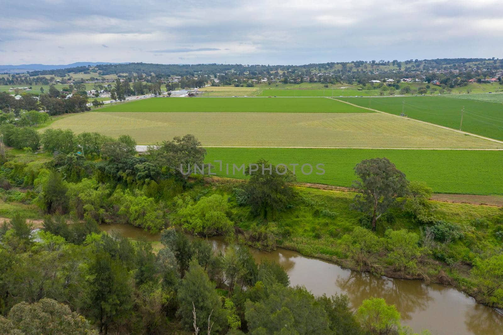 Aerial view of green farmland in regional New South Wales in Australia by WittkePhotos