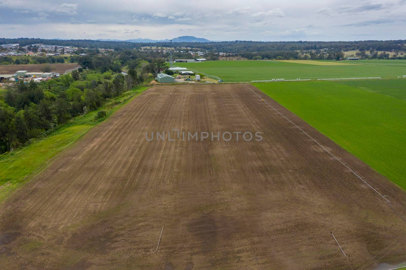 Aerial view of green farmland in regional New South Wales in Australia by WittkePhotos