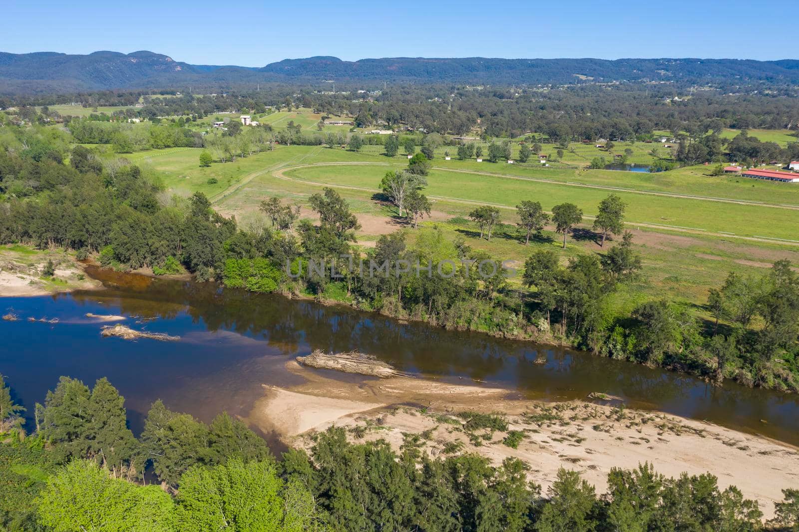 Aerial view of the Hawkesbury River running through agricultural farmland in regional New South Wales in Australia