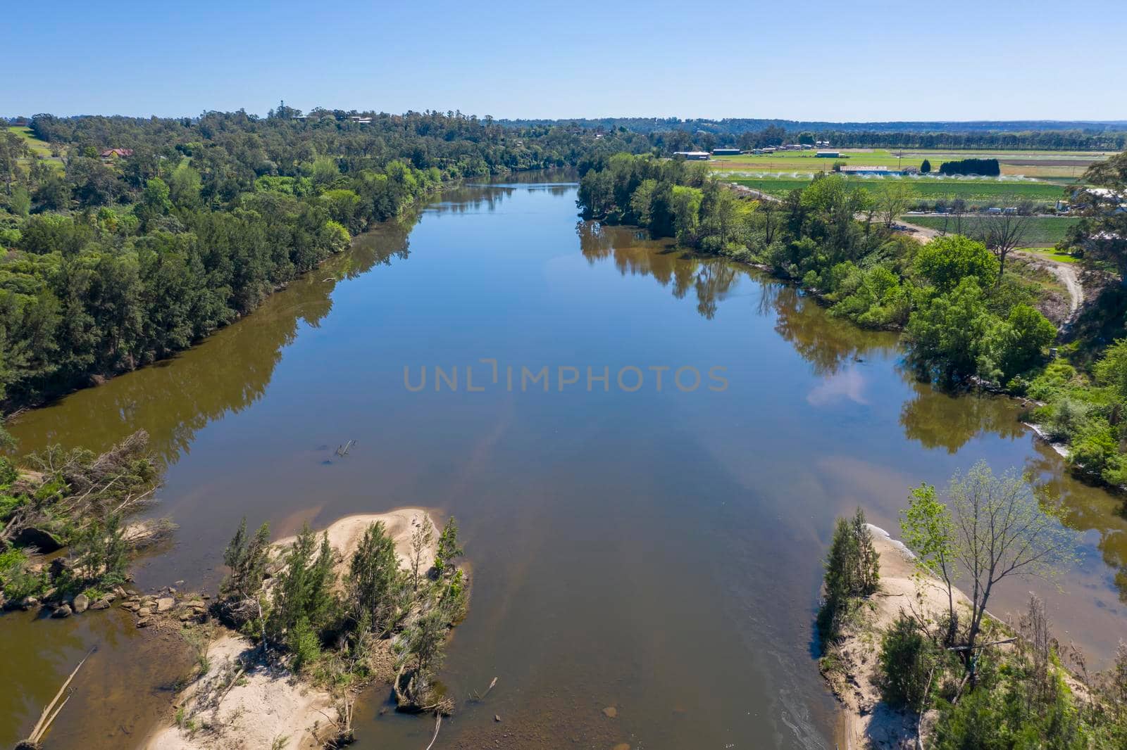 Aerial view of the Hawkesbury River running through agricultural farmland in regional New South Wales in Australia