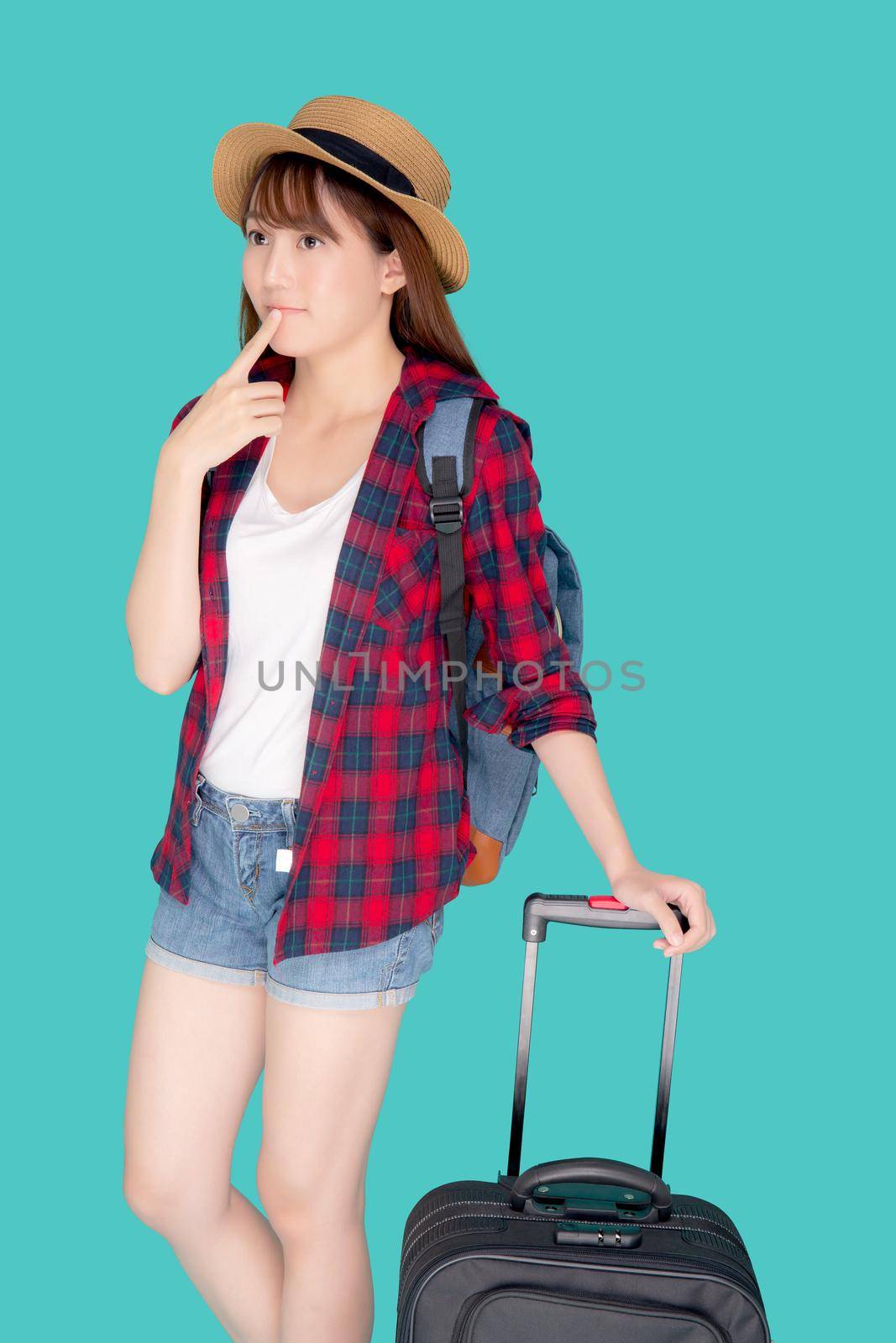 Beautiful young asian woman pulling suitcase isolated on blue background, asia girl having expression is cheerful holding luggage walking in vacation with excited, journey and travel concept. by nnudoo