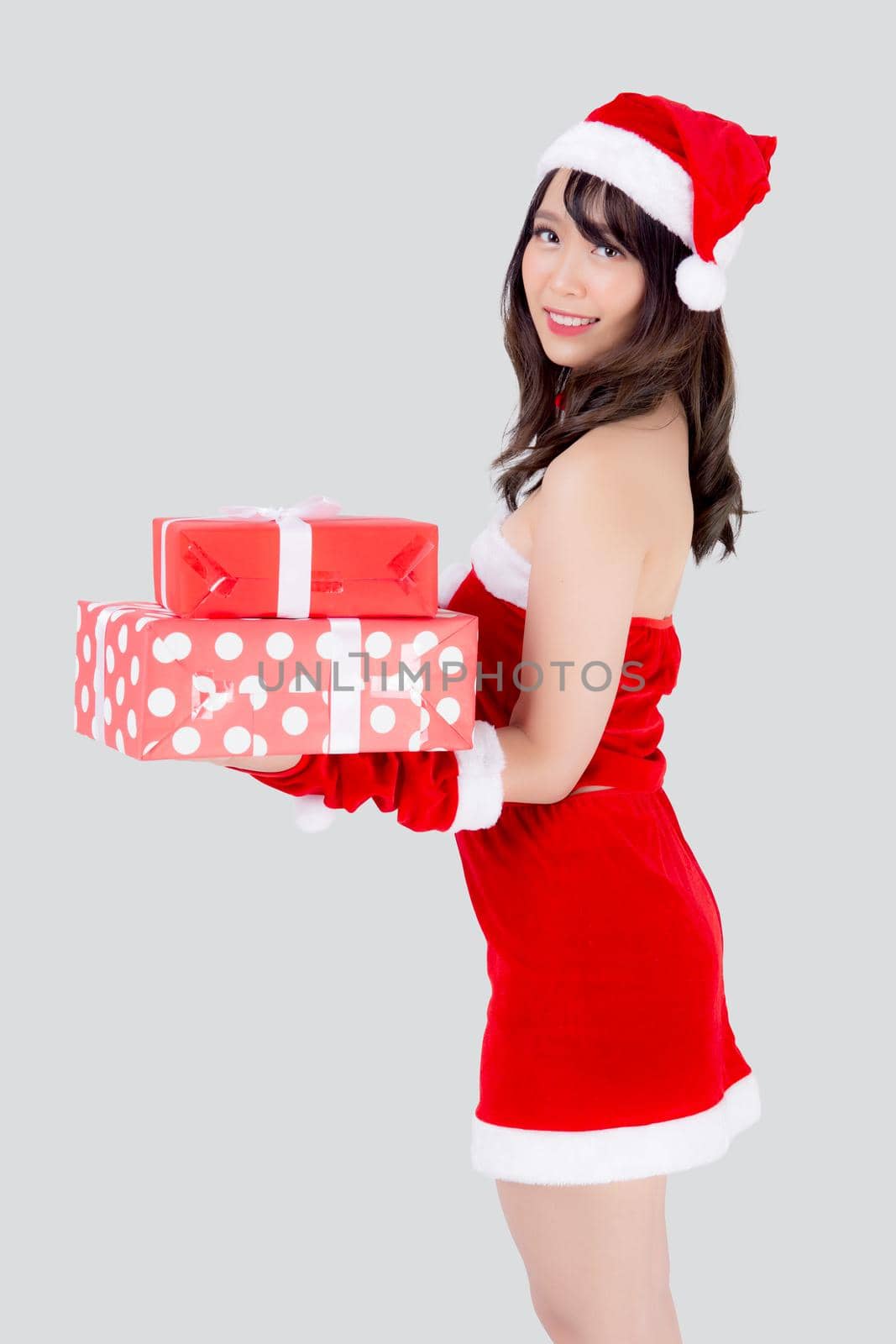 Beautiful portrait young asian woman happy holding lot of gift box with excited in xmas holiday isolated on white background, asia girl surprise and celebrating in festive Christmas and new year. by nnudoo