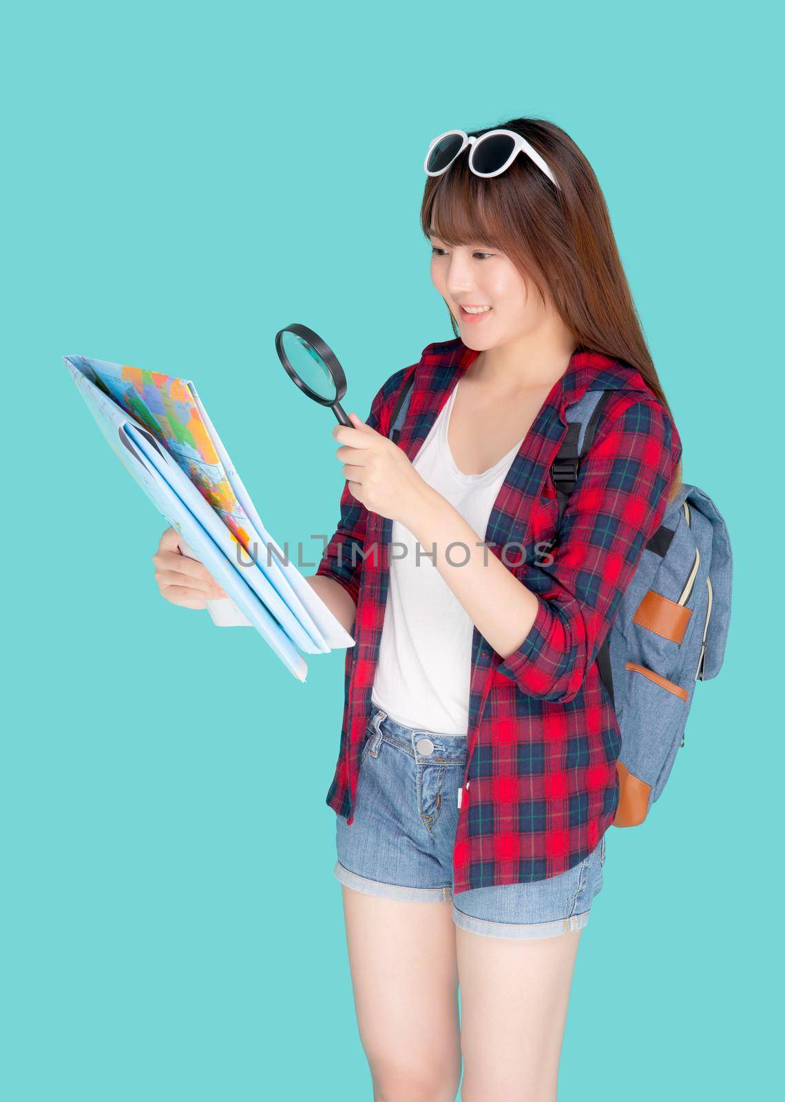 Beautiful portrait young asian woman looking map world with magnify glass for planning guide to travel summer trip, asia girl search route and location for destination of journey in vacation.  by nnudoo