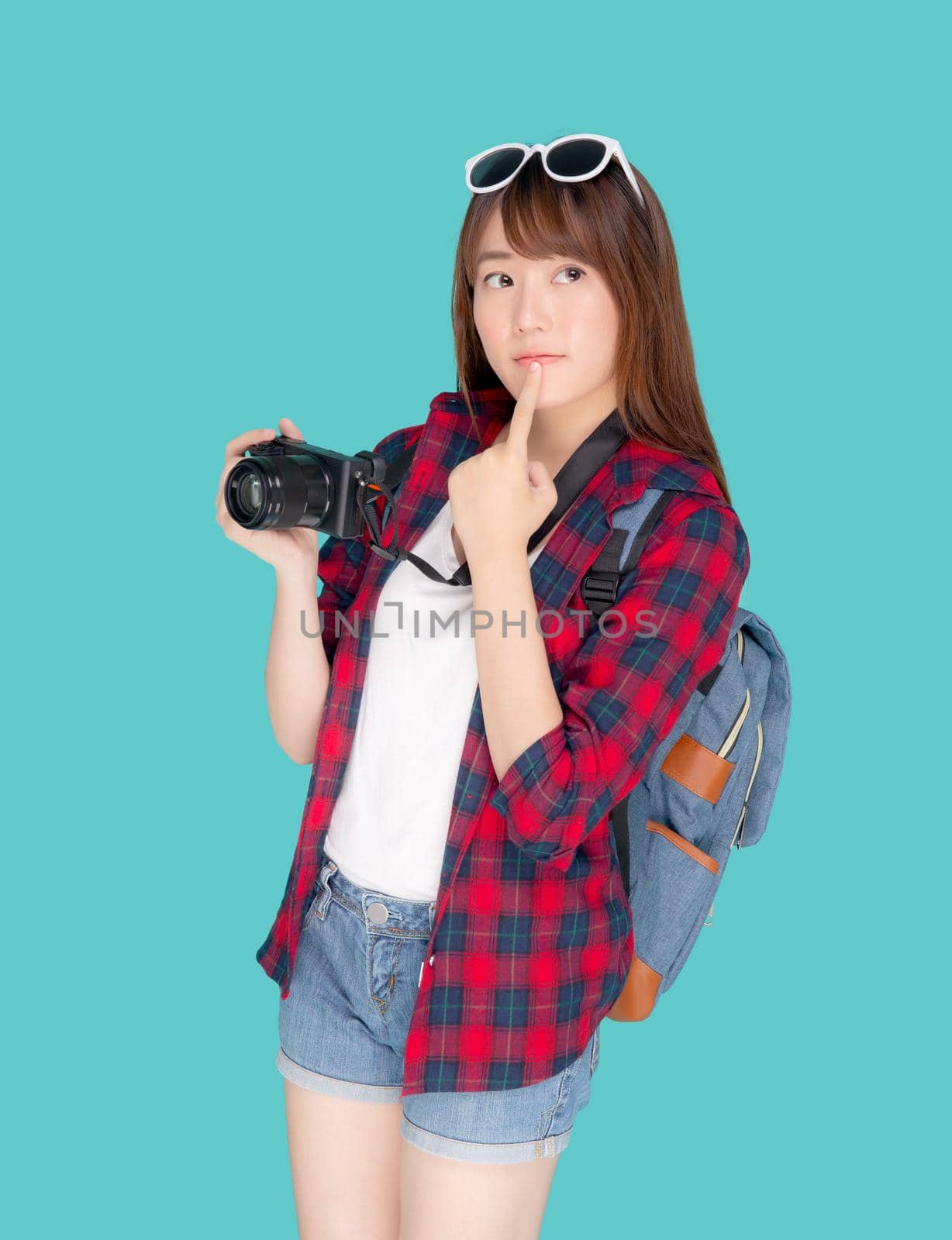 Beautiful young asian woman thinking idea travel trip summer isolated on blue background, asia girl having activity hobby take a photo holding camera, tourist journey in vacation and holiday.
