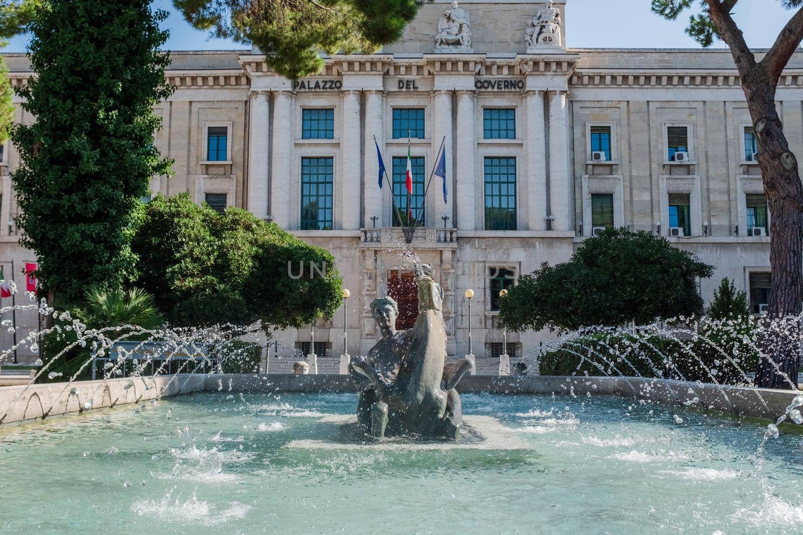 Front view of the fountain "La Pescara", by G. Di Prinzio, bronze sculpture of a woman riding a horse. Government offices for the Province of Pescara (Abruzzo, Italy) in background.