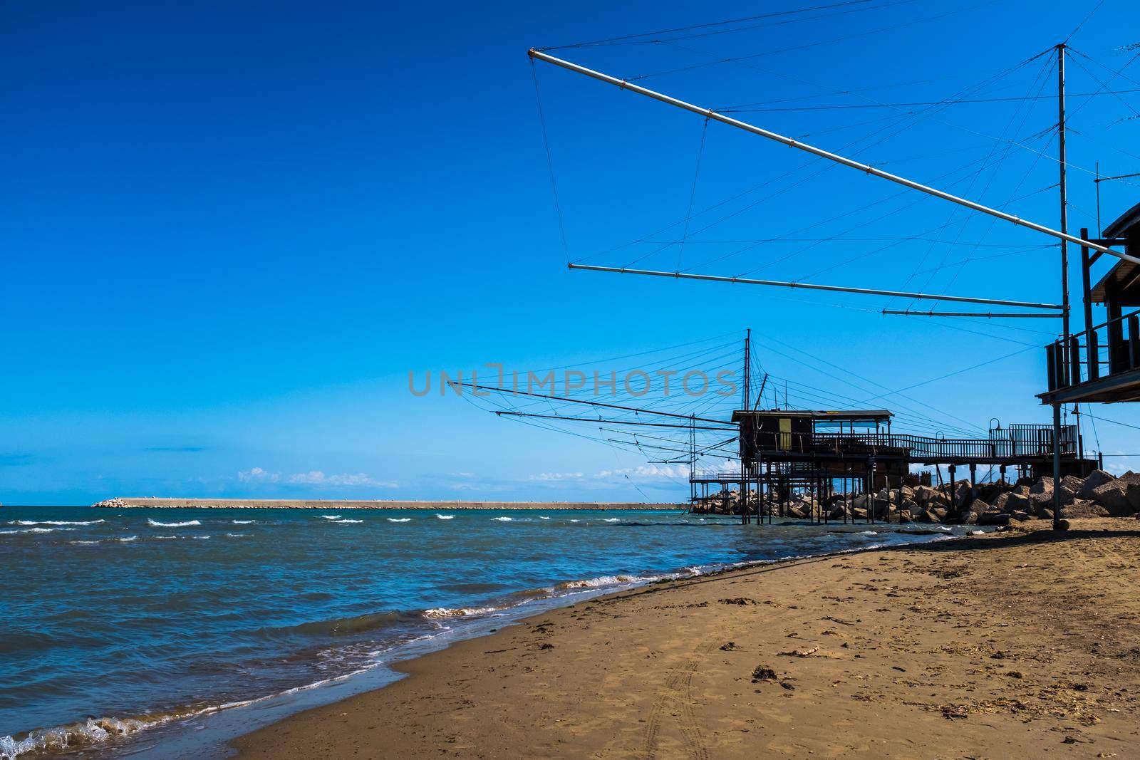 Looking at view of two fishing Trabocchi on sight close to the pier at the Port of Pescara (Abruzzo Region, Italy). by Riccarduska
