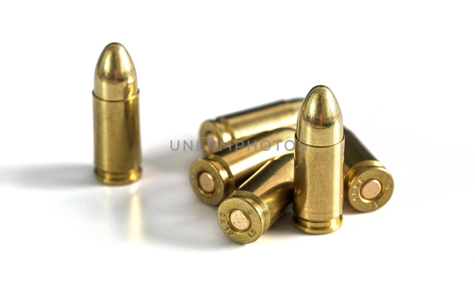 Yellow brass ammo bullets isolated on white background.