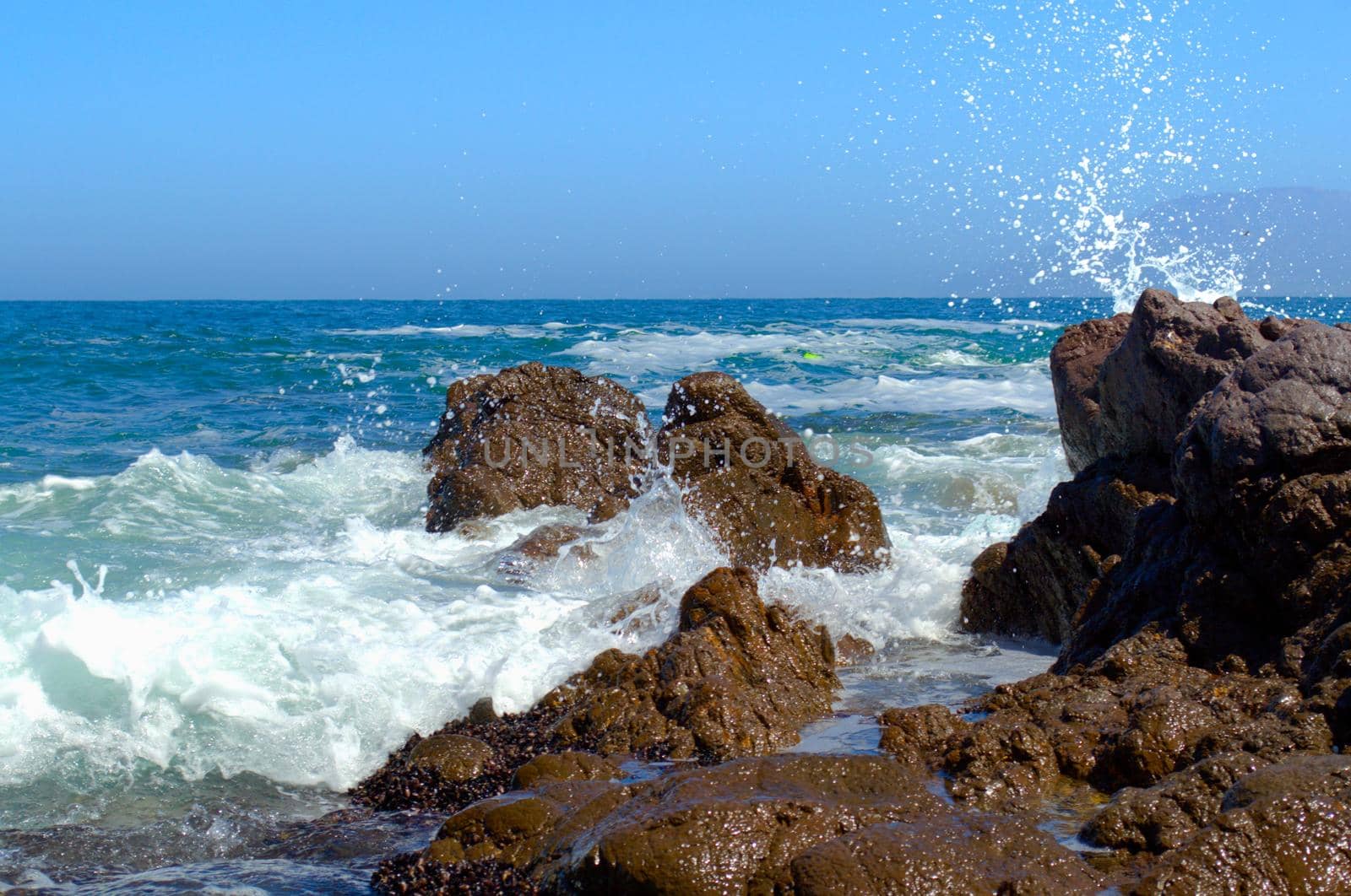 Sea waves crash against the rocks in Antofagasta, Chile. by hernan_hyper