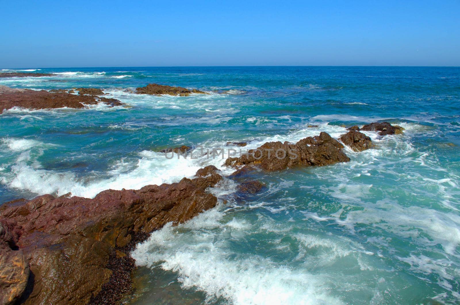 Sea waves crash against the rocks in Antofagasta, Chile.
