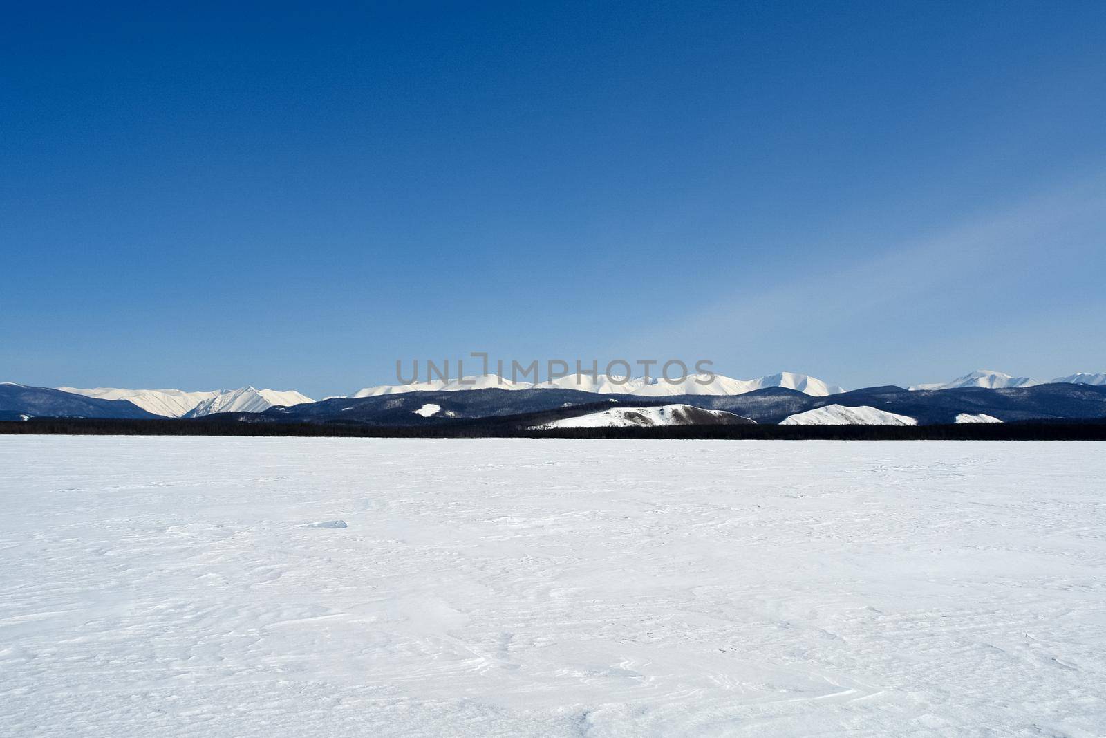 Baikal mountains in winter in snow. Forest in snow-covered mountains.