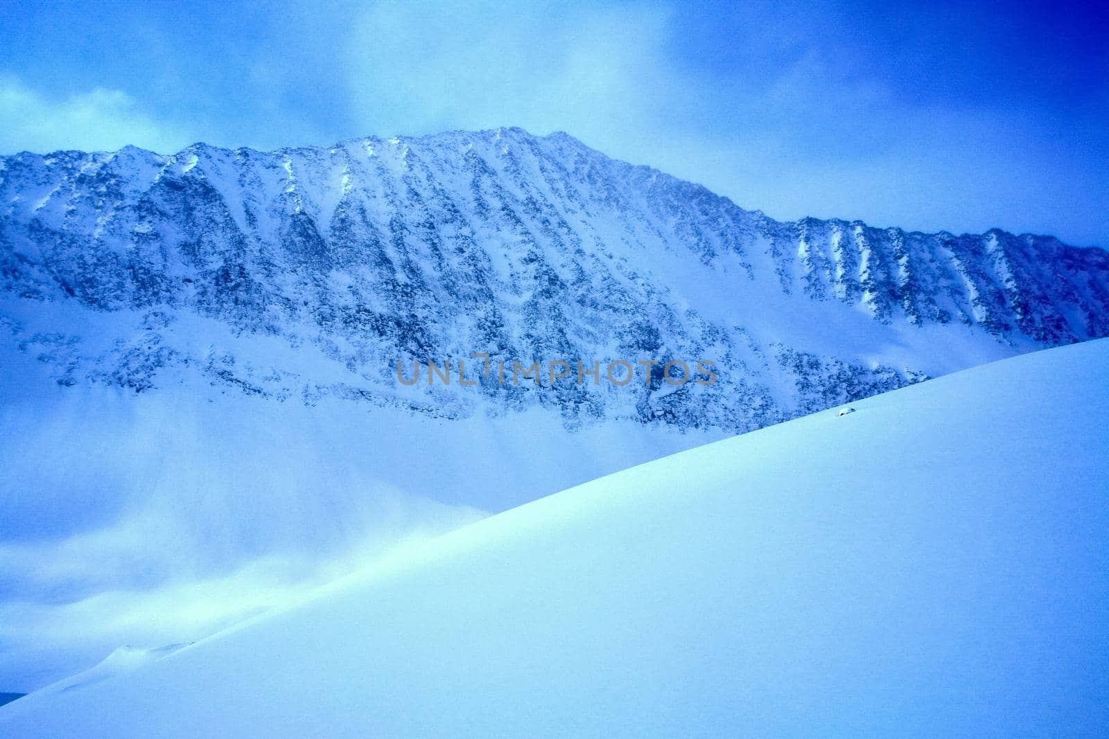 Baikal mountains in winter in snow. Forest in snow-covered mountains.