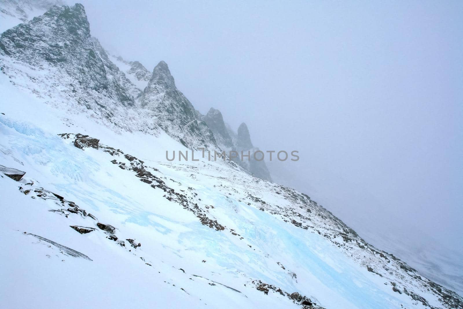 Baikal mountains in winter in snow. Forest in snow-covered mountains.