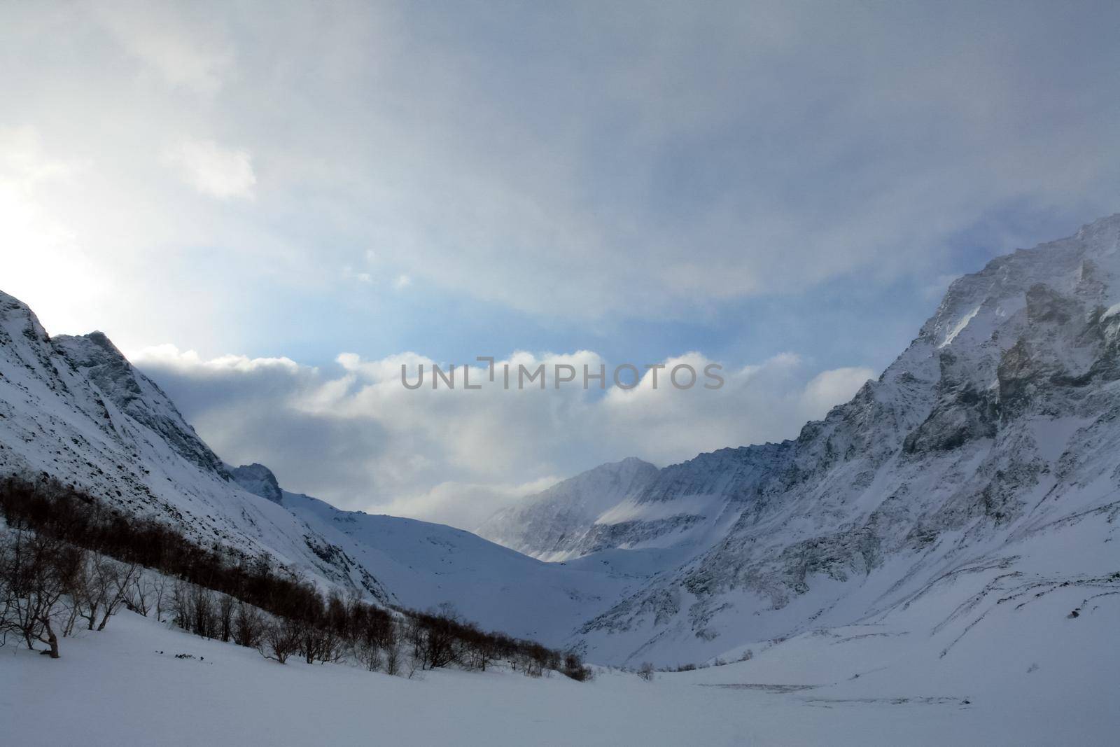 Baikal mountains in winter in snow. Forest in snow-covered mountains.