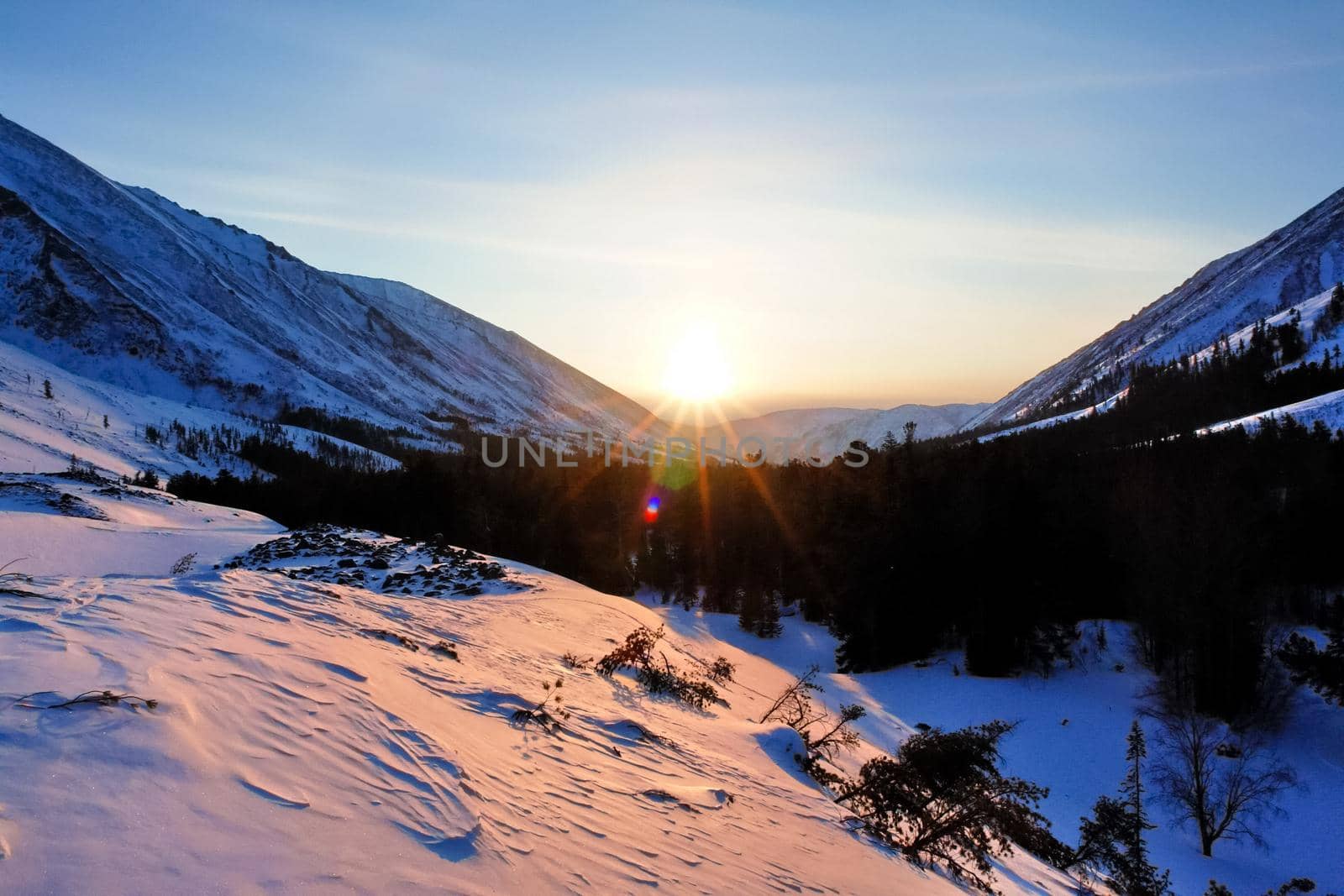 Baikal mountains in winter in snow. Forest in snow-covered mountains.