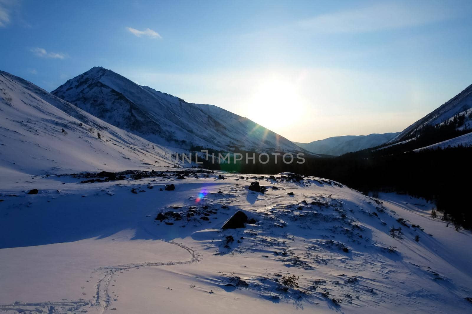 Baikal mountains in winter in snow. Forest in snow-covered mountains.