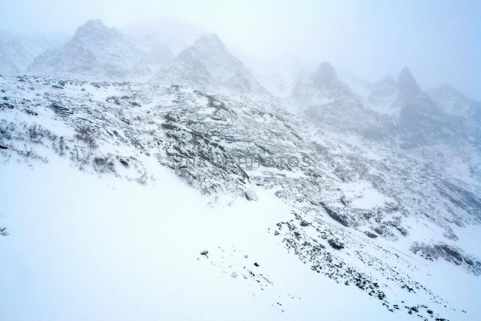 Baikal mountains in winter in snow. Forest in snow-covered mountains.