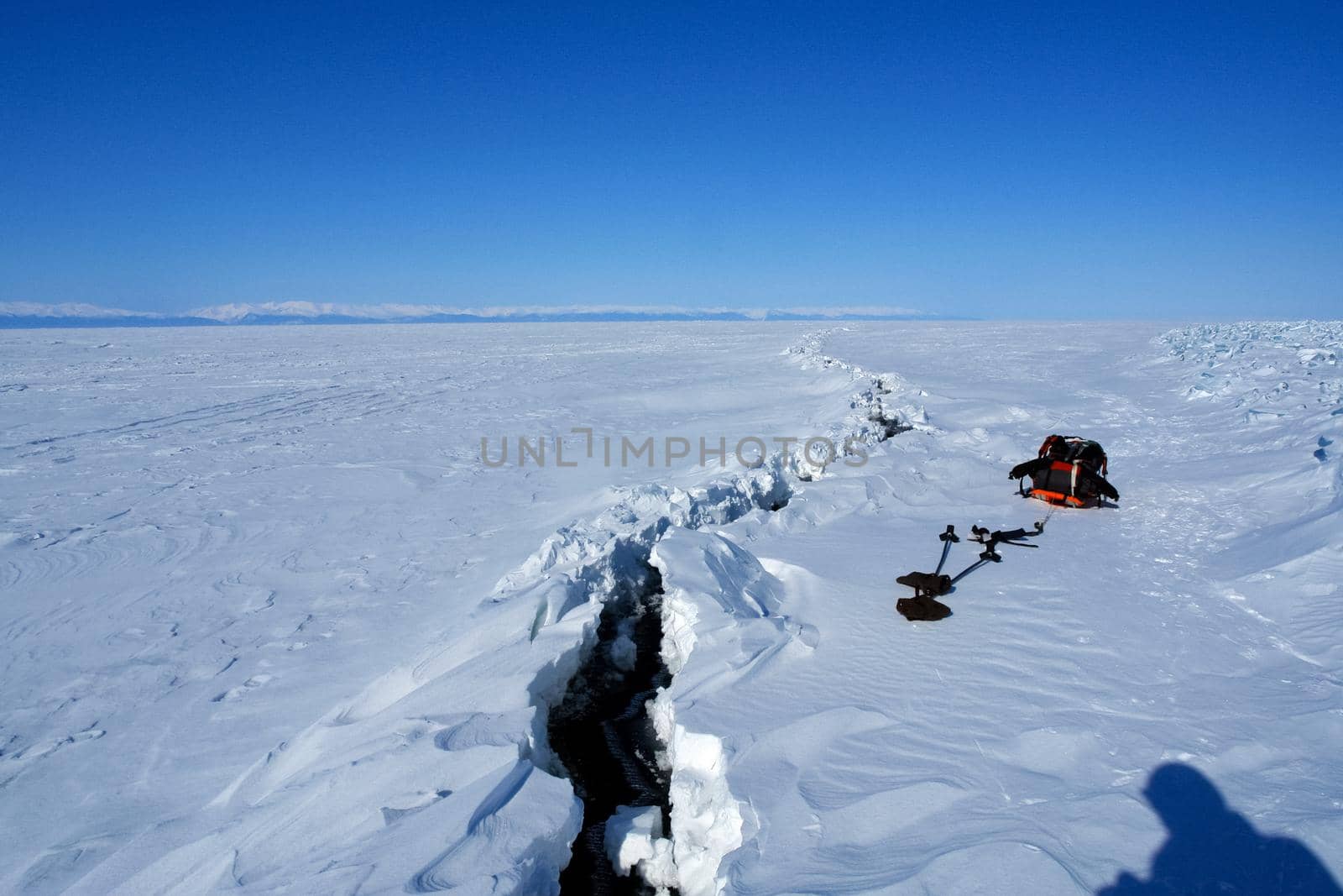 Baikal, long crack on ice, wormwood.