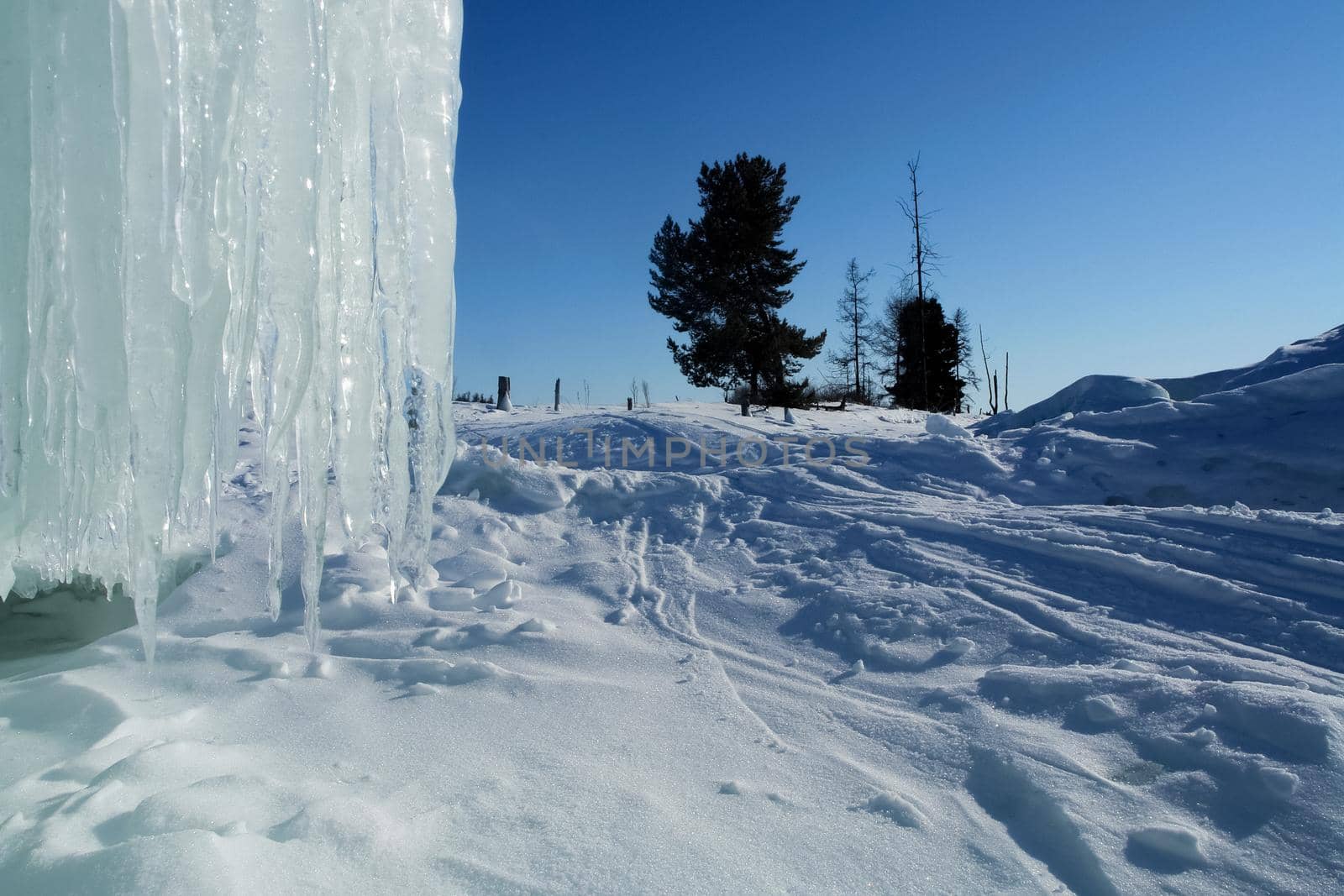 Long icicles hang from rock by DePo