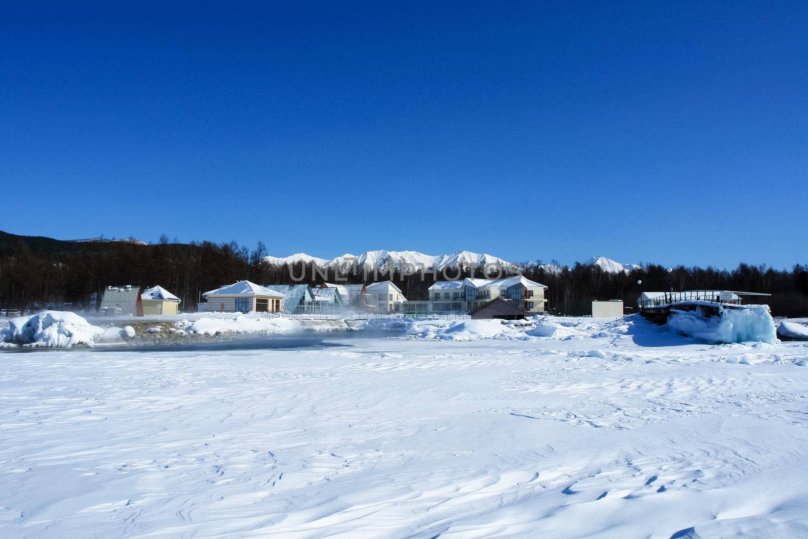 The shore of Lake Baikal in winter. Snow and ice on the baikal.