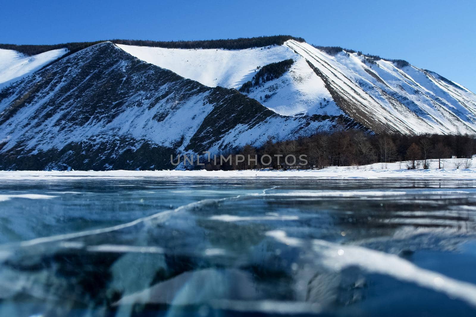 shore of Lake Baikal in winter. Snow and ice on the baikal. by DePo