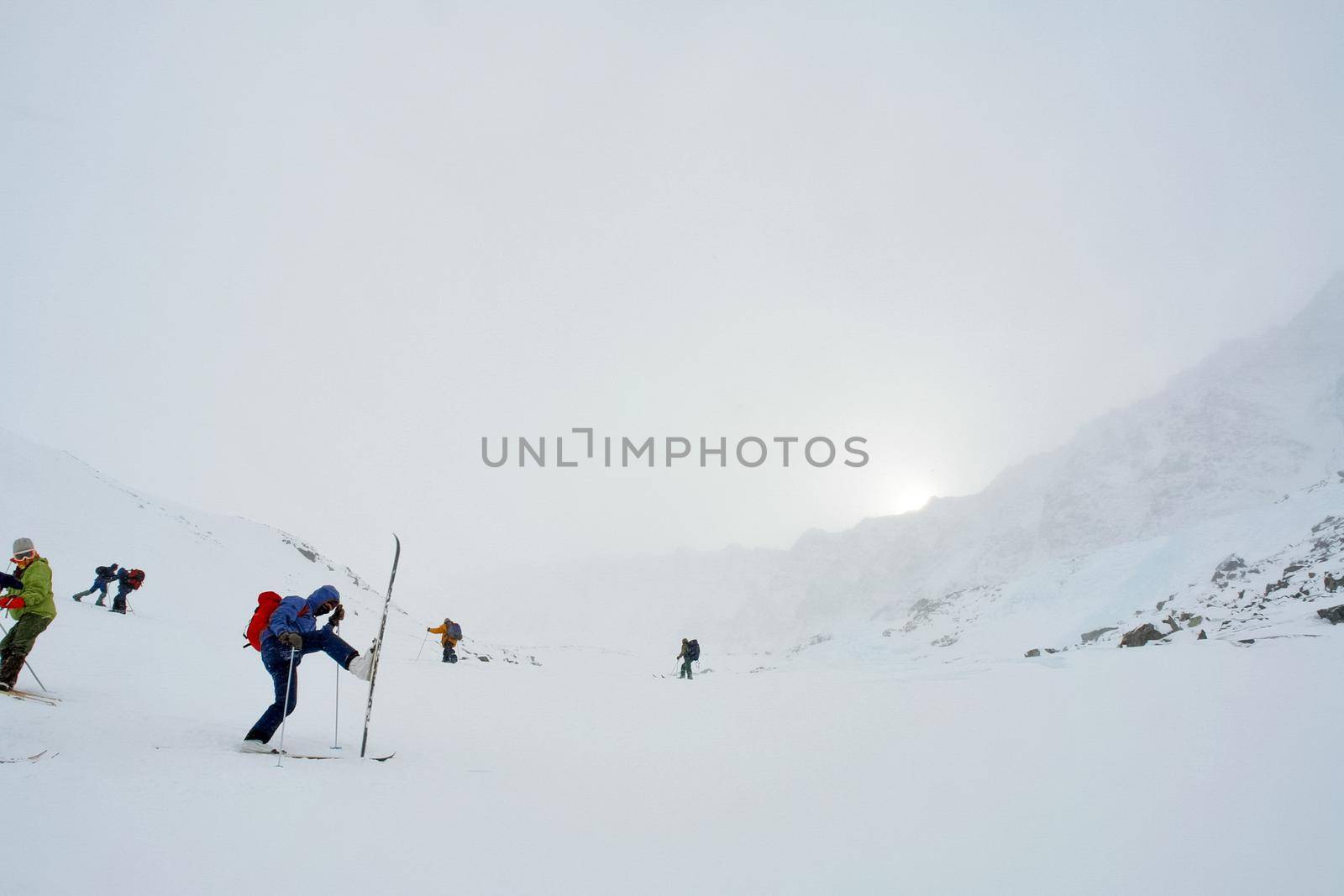 Skiers ride in the snow in the mountains of Baikal by DePo