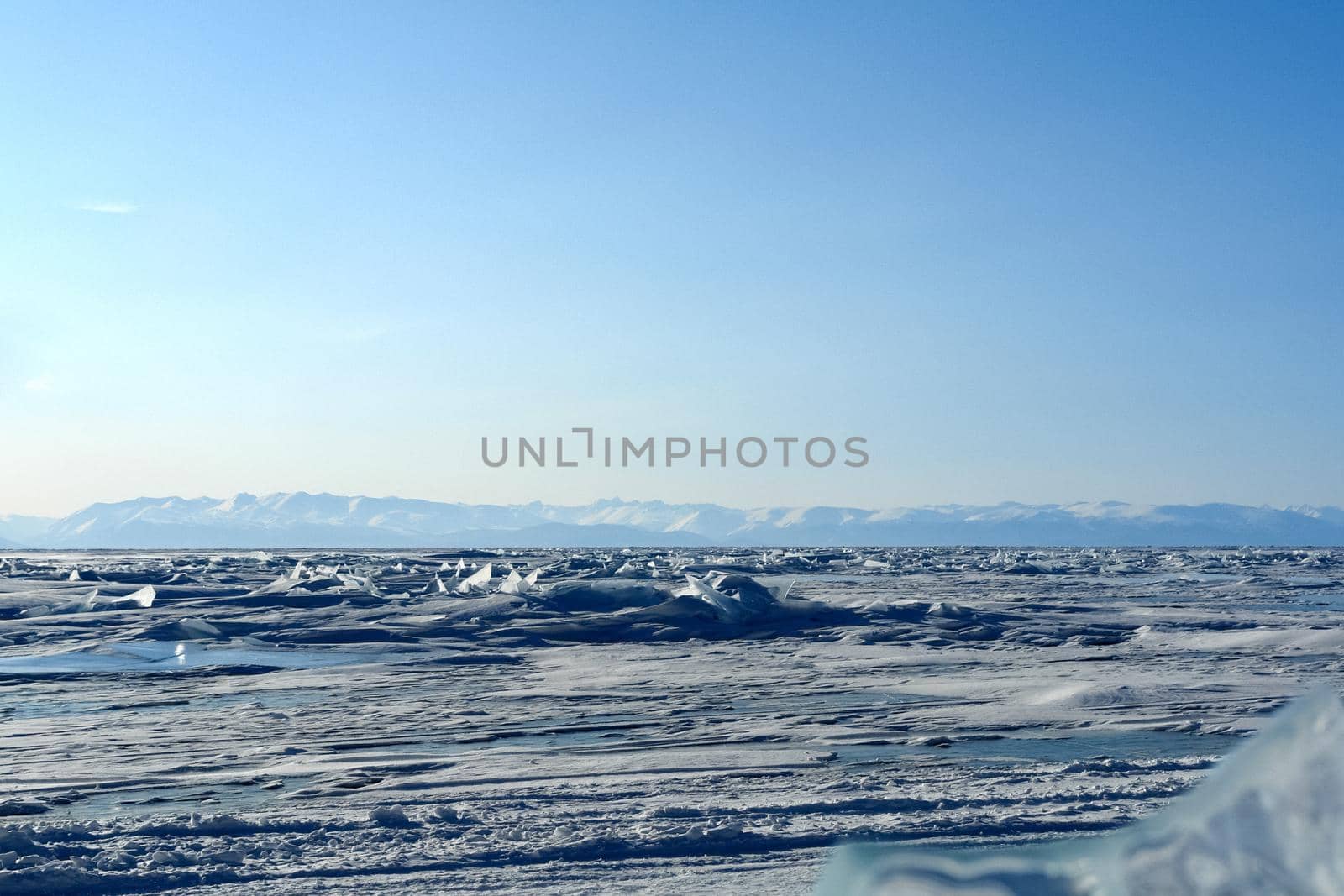 winter landscape of Lake Baikal. Beautiful mountains in the snow and sky by DePo