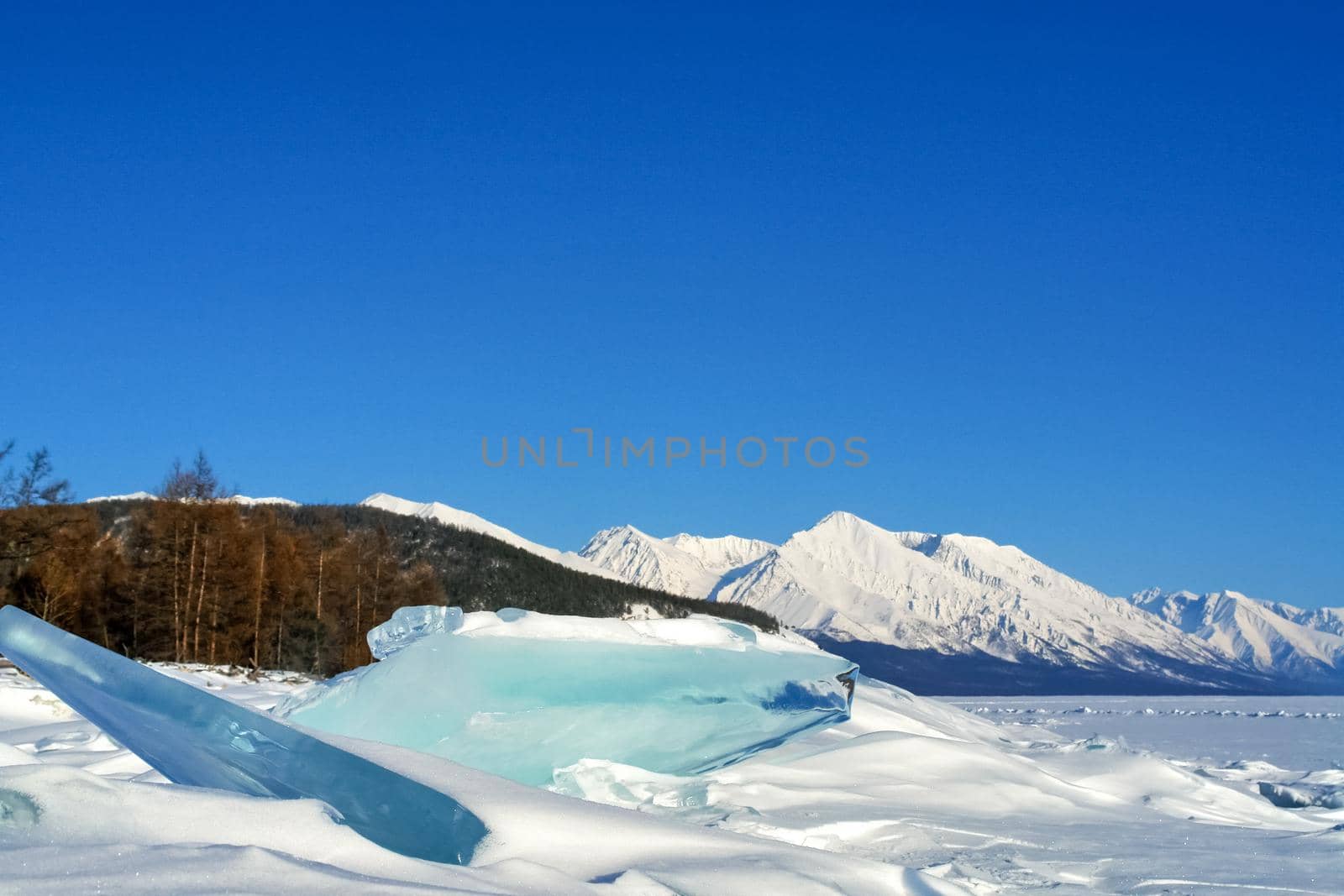 winter landscape of Lake Baikal. Beautiful mountains in the snow and sky by DePo