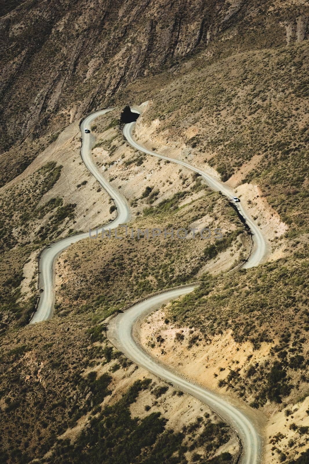 Narrow twisting dirt road across the Andes Mountains in Mendoza, Argentina.