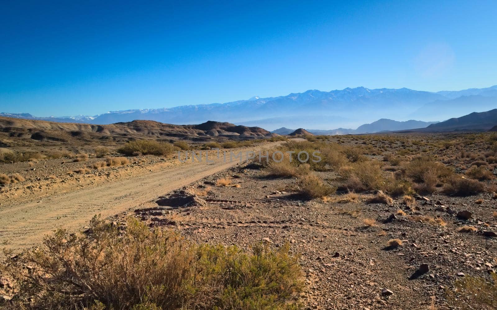 Dirt road across the Andean desert in Uspallata, Mendoza, Argentina.