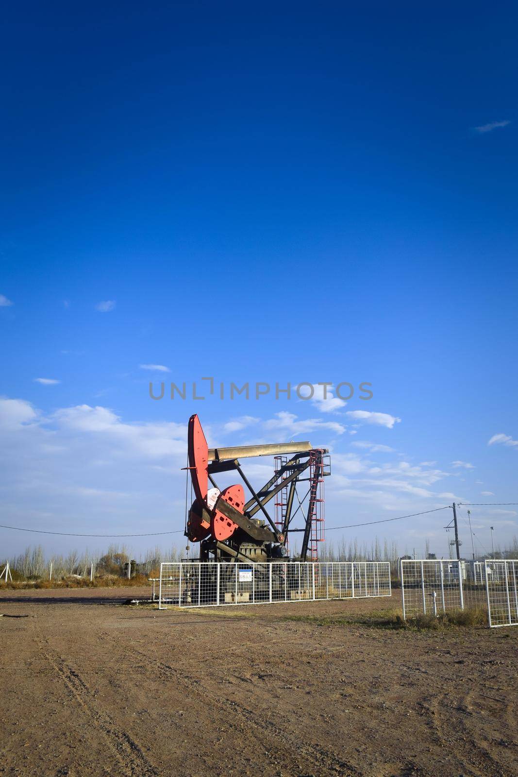 Oil extraction pumpjack in the desert of Mendoza, Argentina. by hernan_hyper