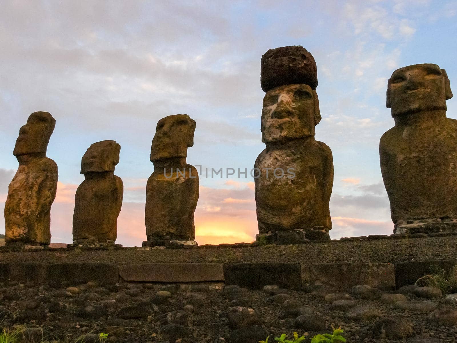 Statues of Easter Island in the background of the sunset. melting of the Easter statue in the sunlight of the sunset. by DePo