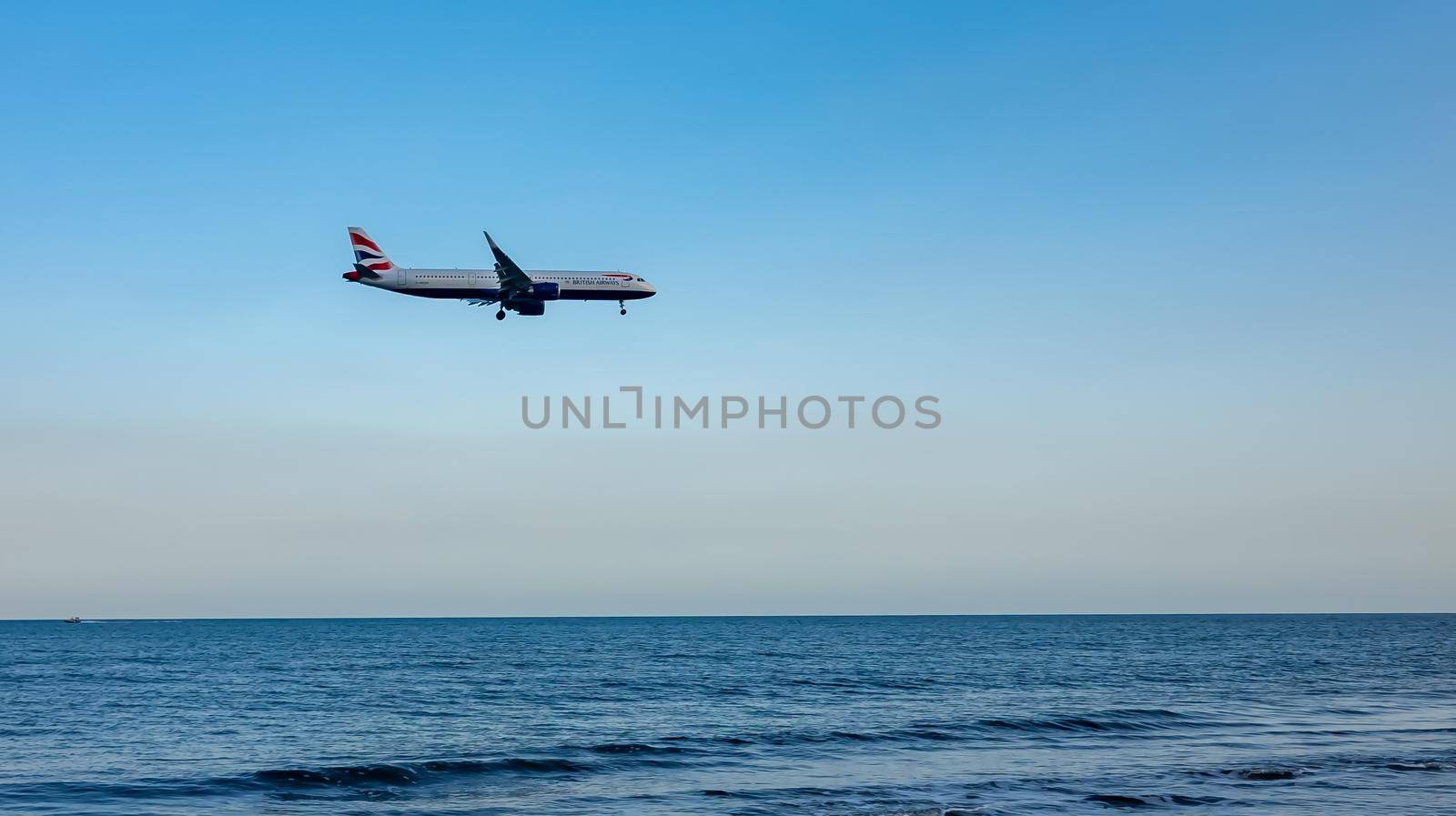 April 11, 2019 Larnaca, Cyprus. Plane of airline 
British Airways comes in to land over the waters of the Mediterranean sea.