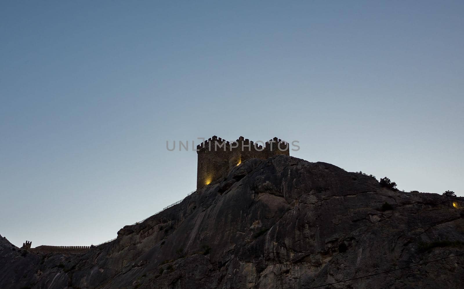 Genoese fortress on a high cliff on the Black Sea coast in Sudak in the late evening.