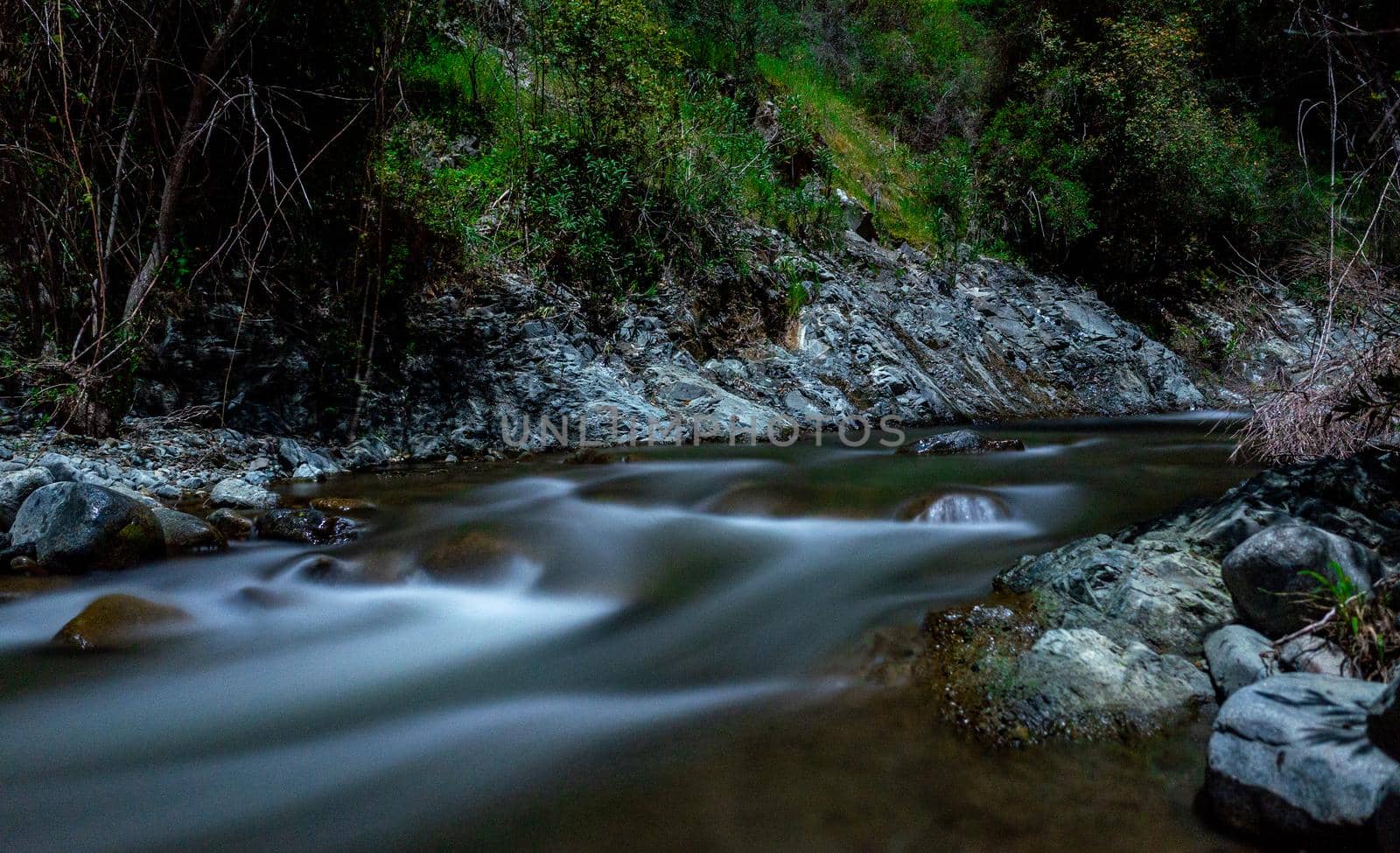 Rapid flow of the river in the mountains of the island of Cyprus at dusk.