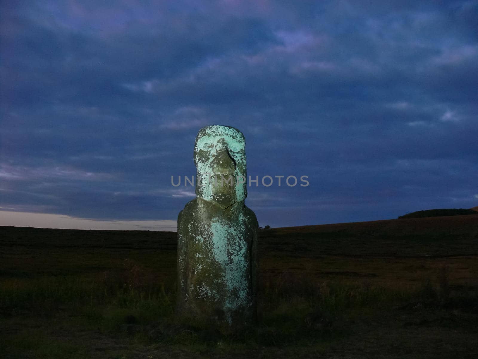 Statues of Easter Island in the background of the sunset. The melting of the Easter statue in the sunlight of the sunset.