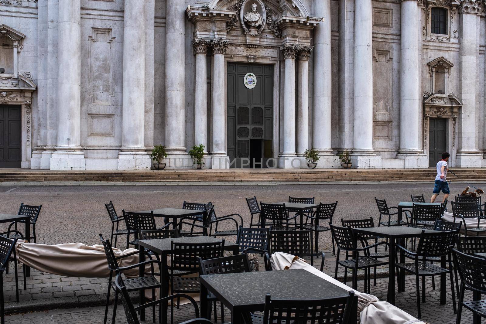 Picture shows deserted outdoor tables and chairs in front of the New Cathedral in Paul VI square in Brescia. Lockdown measures taken in Italy over the coronavirus pandemic will be extended until May.