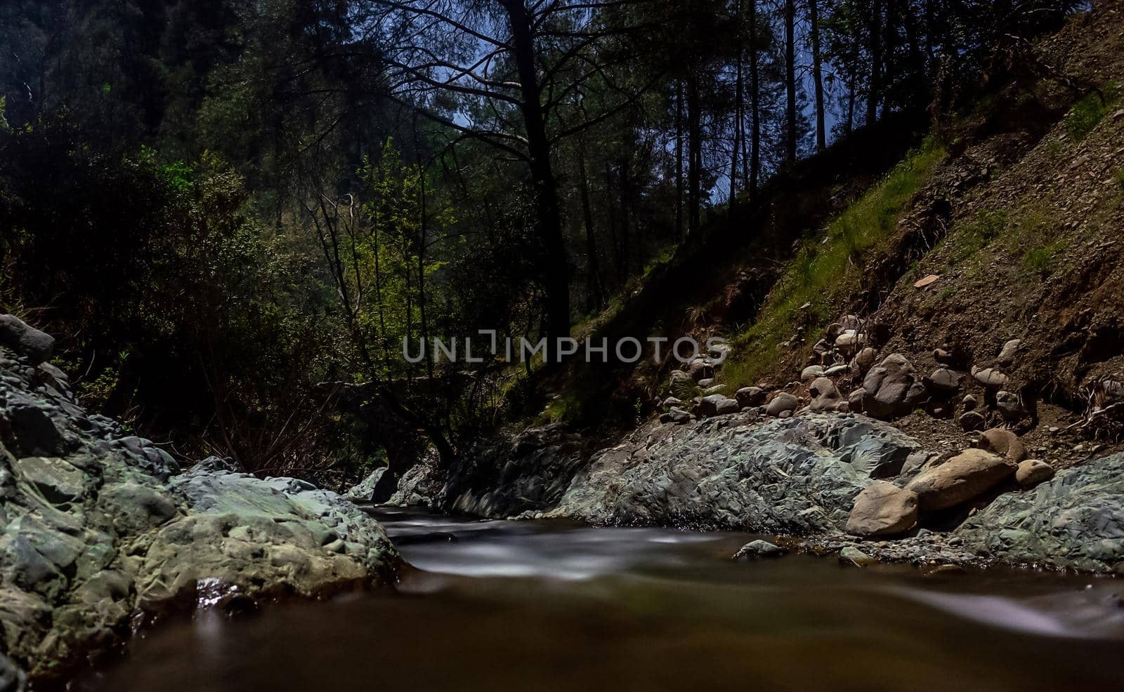 Rapid flow of the river in the mountains of the island of Cyprus at dusk.