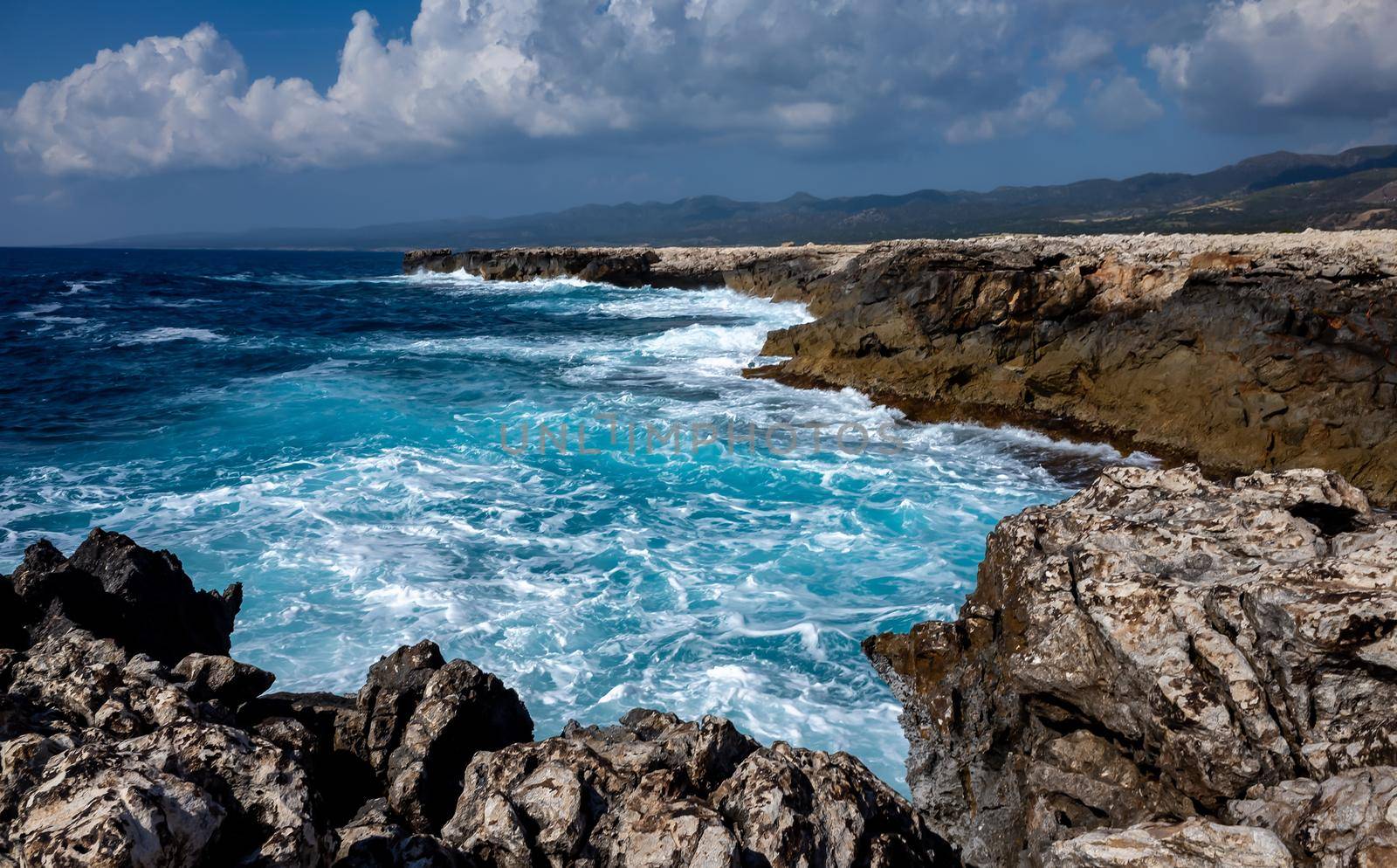 Waves crash on the rocky shore of the Mediterranean Sea on the Akamas Peninsula in the northwest of the island of Cyprus.