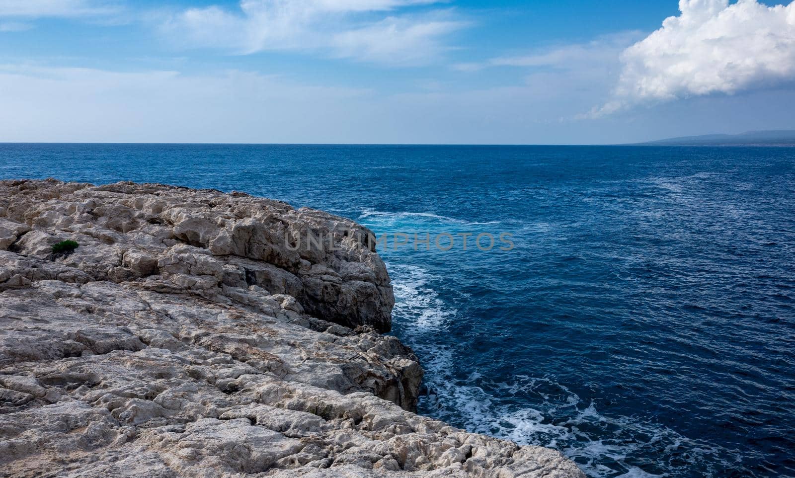 Waves crash on the rocky shore of the Mediterranean Sea on the Akamas Peninsula in the northwest of the island of Cyprus.