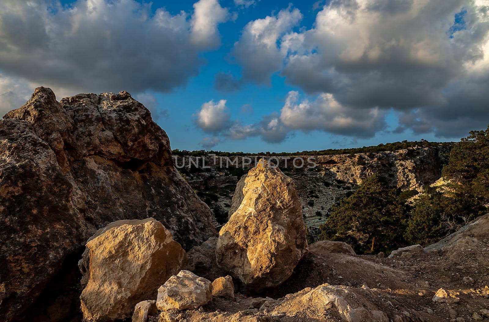 Sandy mountain road of the island of Cyprus in the light of the setting sun.