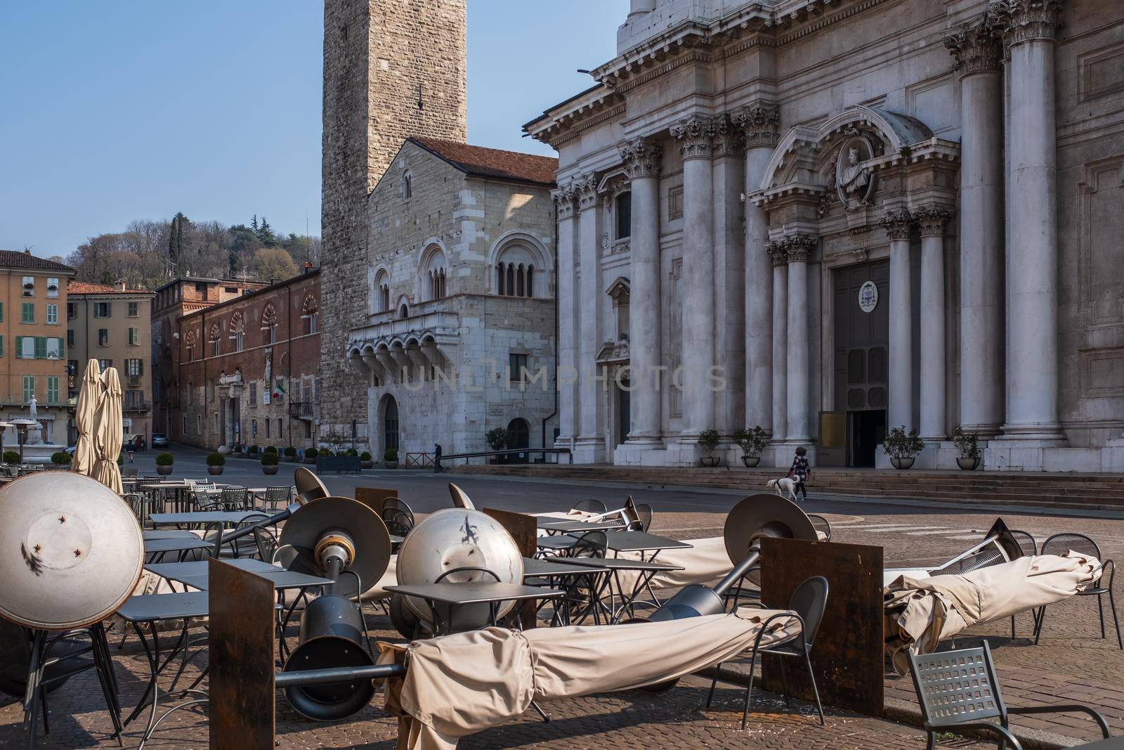 Empty tables outside a bar at Piazza Paolo VI (Paolo VI Square) in Brescia after Italy's government issued a decree with emergency new measures to contain the coronavirus.
