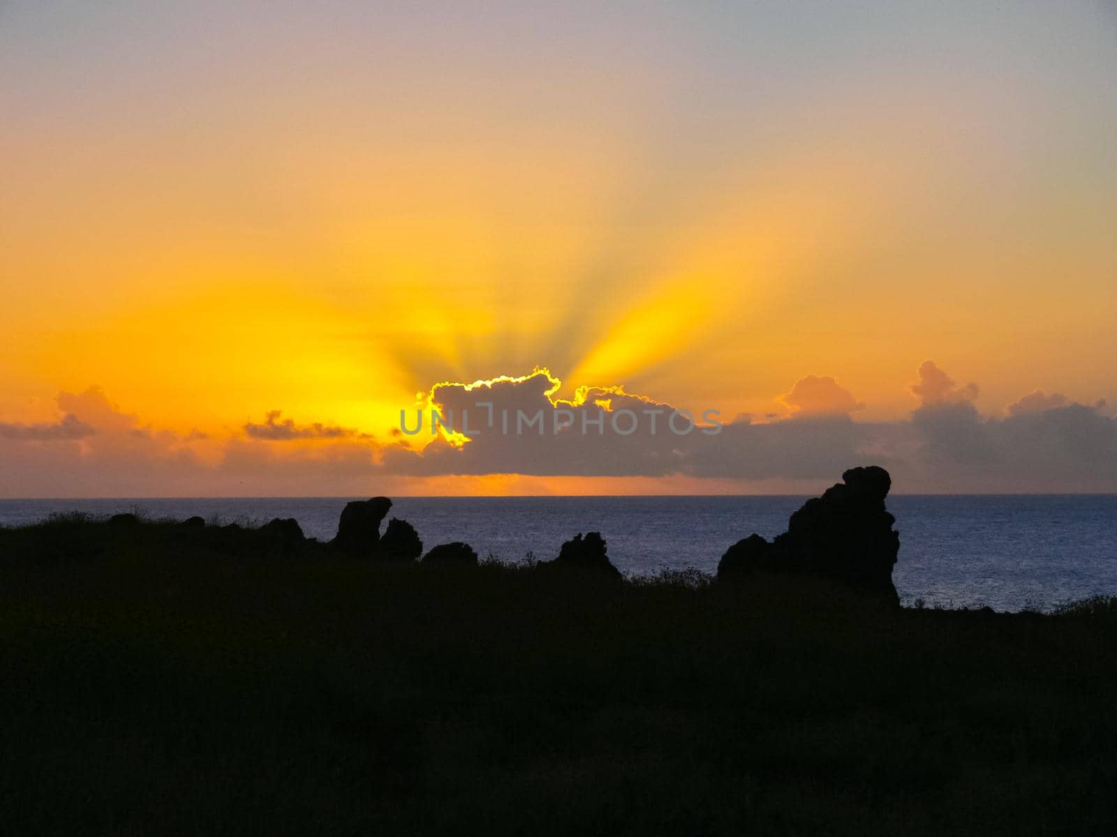 Sunset on Easter Island. The colors of sunset in ocean. by DePo