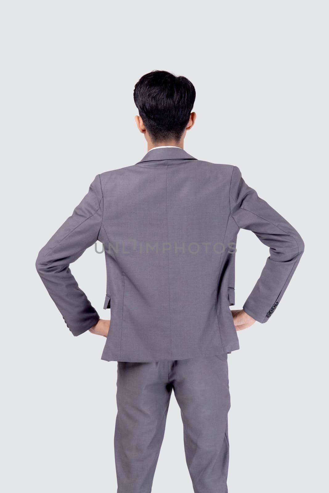 Rear view of young asian businessman in suit with confident isolated on white background, back of portrait business man is manager or executive or employee thinking with success. by nnudoo