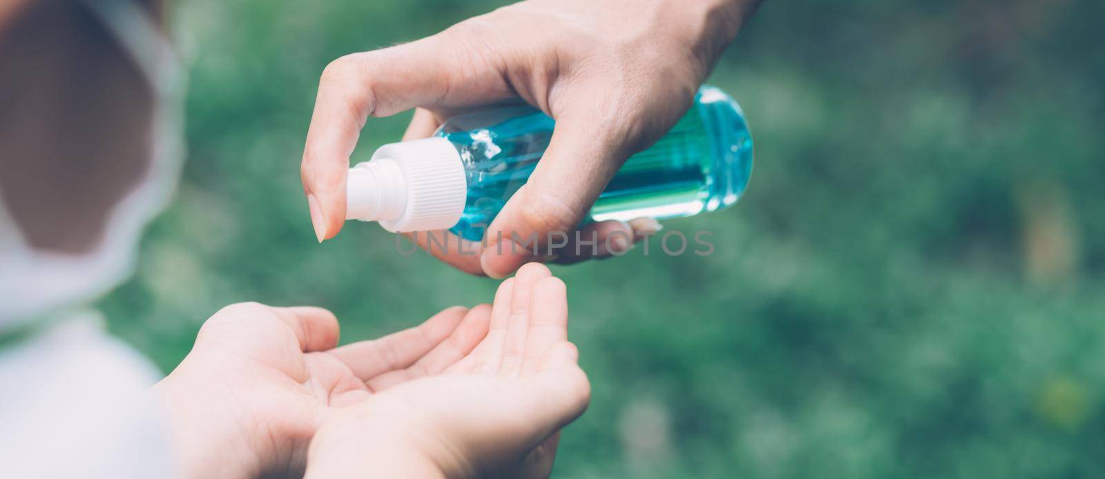 Mother take care son with sanitizer for protection disease flu or covid-19 with cleaning hand, child wash hand for safety for outbreak of pandemic, hygienic and lifestyle concept, banner website.