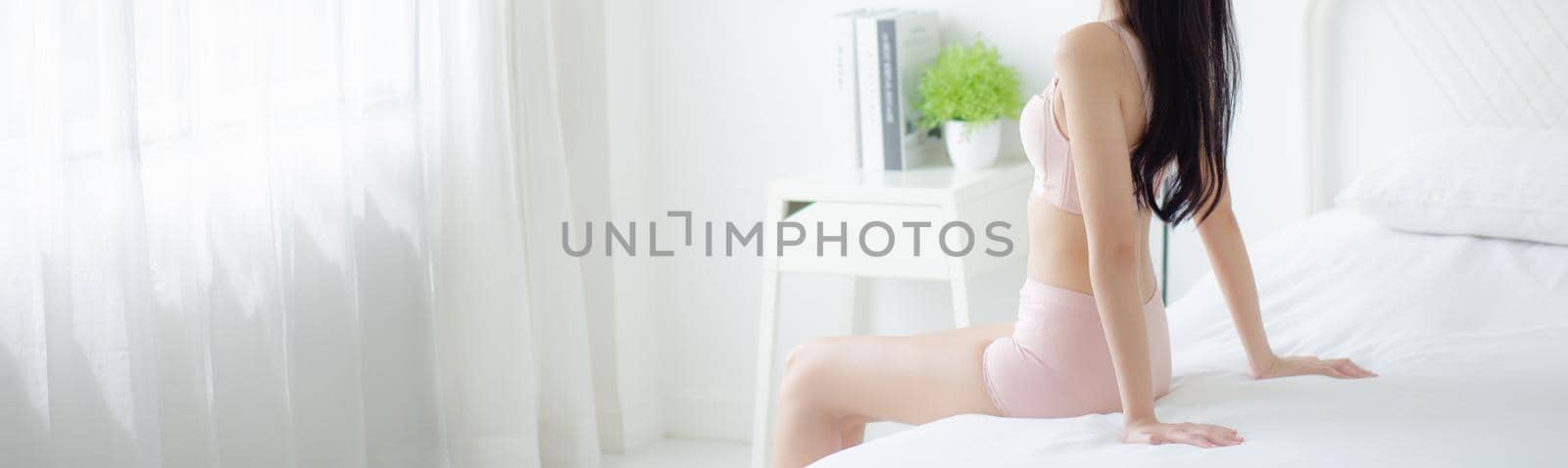 Beautiful young asian woman wake up and sitting and looking windows in the morning with cozy, sexy girl in underwear relax and resting in the vacation with comfort, lifestyle concept, banner website. by nnudoo