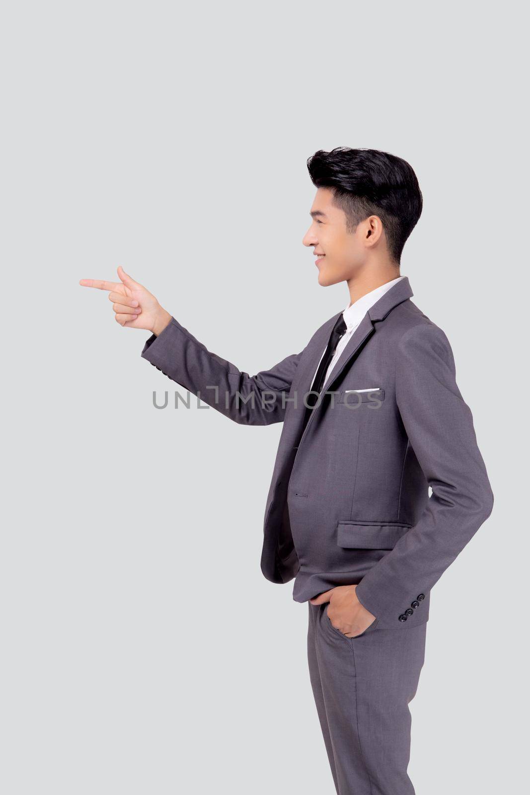 Portrait young asian business man pointing and presenting isolated on white background, advertising and marketing, executive and manager, male confident showing success, expression and emotion. by nnudoo