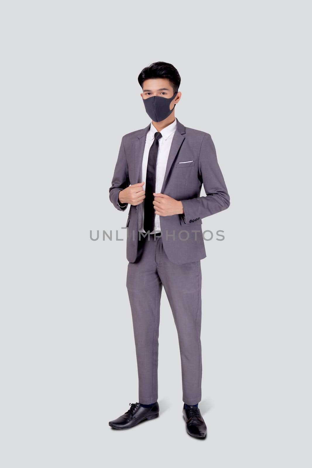 Portrait young asian businessman in suit confident wearing face mask for protective covid-19 isolated on white background, business man medical mask, quarantine for pandemic coronavirus.